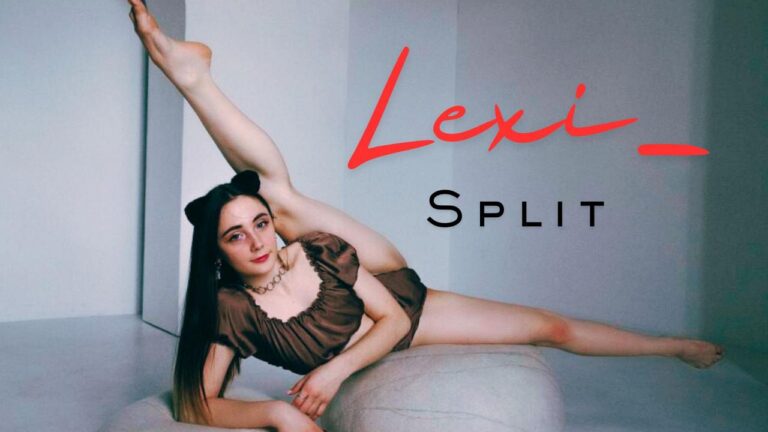 Lexi_Split doing the splits lying on the floor looking at the camera